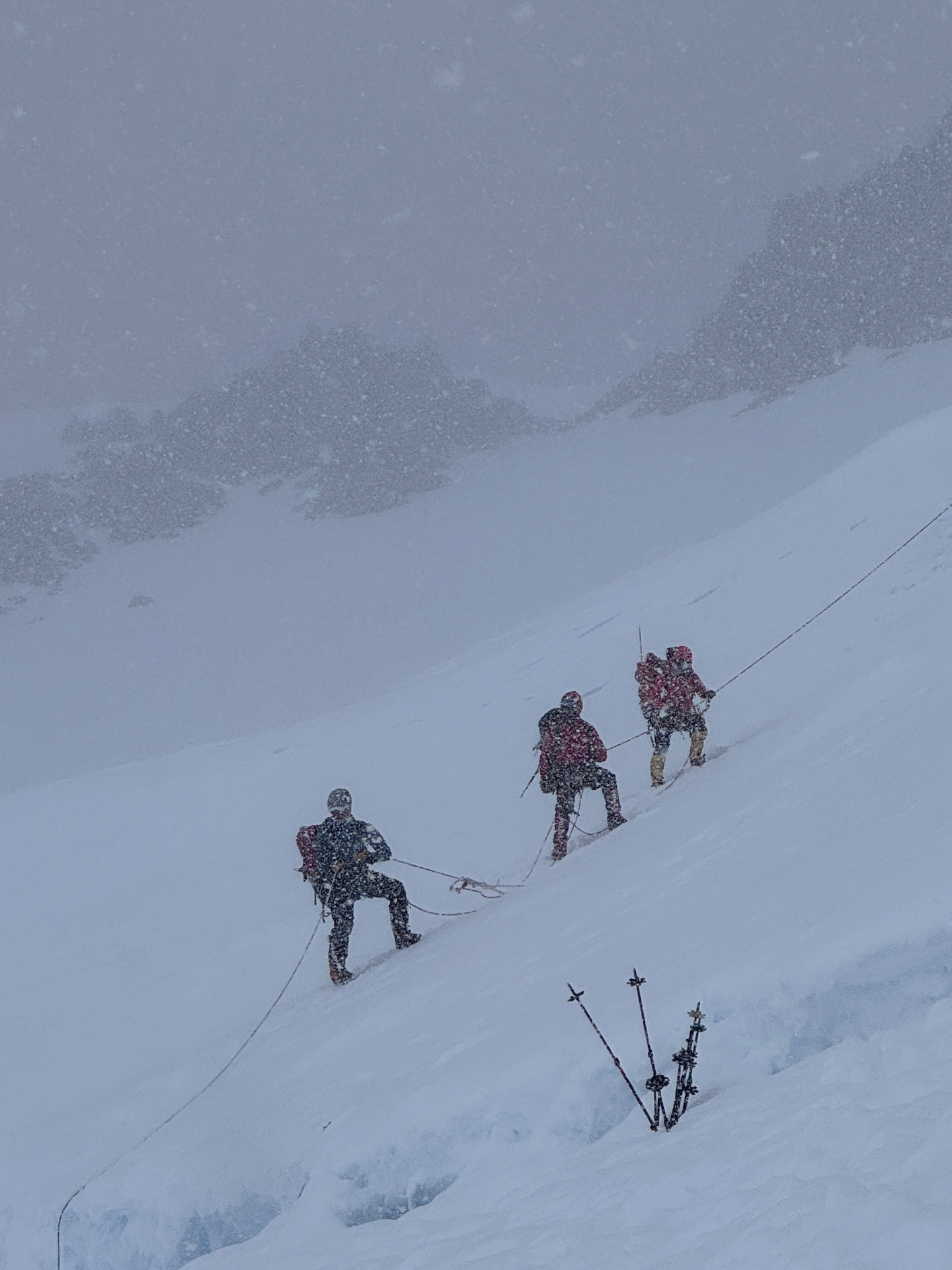A climber pushing on through a storm